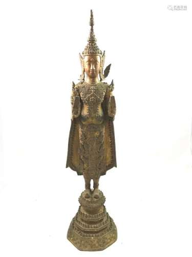 Partially gold lacquered bronze subject representing the Buddha, adorned and richly clothed, standing on a high base with both hands in abhaya- mudra