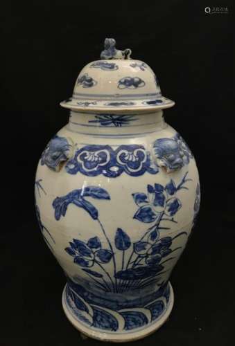 Covered jug in Chinese porcelain decorated in cobalt blue on a white background. The shoulder is decorated with three masks of Ruyi grimacing. Floral decoration on the belly.