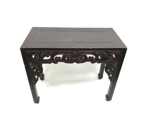 Lacquered wooden console with carved and openwork decoration of volutes, the square-sectioned legs carved with geometric motifs. Length: 105.5 cm. Width: 53 cm. Height: 91 cm. Wear and scratches on the top.