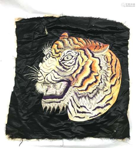 Silk satin textile element embroidered with the linen thread of a tiger's head. South China. Indochina. Tears outside the motif. Height. 55cm, Width. 55 cm for the tiger.