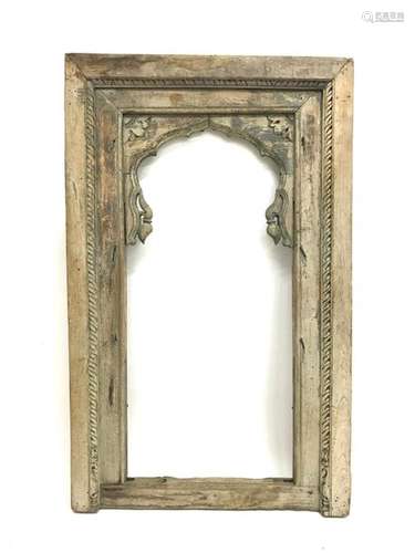 Polychrome carved wooden architectural element consisting of an openwork frame with a window, the upper part forming a polylobed arch carved with plant motifs. Height : 157 cm. Width : 95,5 cm. Depth : 8.8 cm.