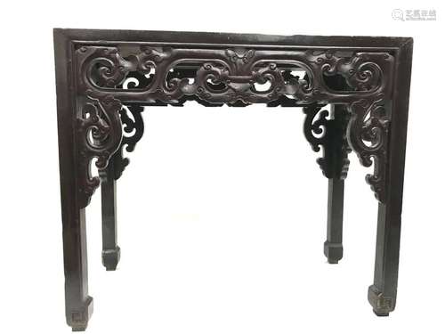 Lacquered wooden console with carved and openwork decoration of volutes, the square-sectioned legs carved with geometric motifs. Length: 105.5 cm. Width: 53 cm. Height: 91 cm. Wear and scratches on the top.