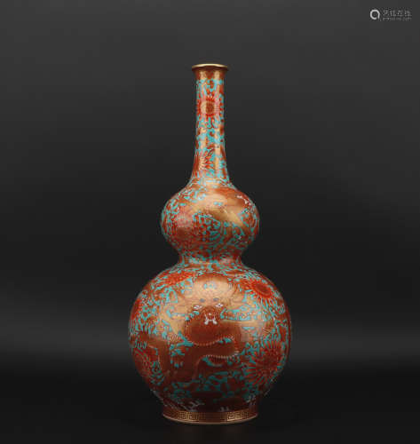 A allite red glazed 'dragon' vase painting in gold