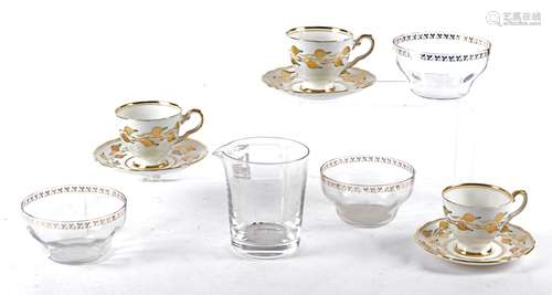 Twelve Royal Chelsea gilt cups and saucers, with hand painted decoration of budding plant life,