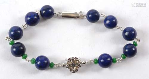 A bracelet with spherical lapis lazuli beads, with a panther's head and interspersed with