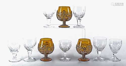 Three amber glass brandy glasses together with a quantity of Stuart crystal drinking glasses, the