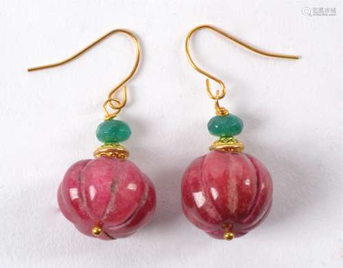 A pair of earrings with semi precious red stones similar to rubies, melon cut with mounted green