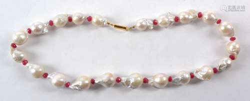 A baroque pearl and semi precious red stone necklace, length 21cm