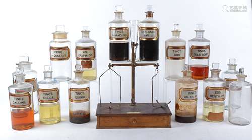 A collection of late 19th or early 20th Century pharmaceutical bottles, thirteen with original