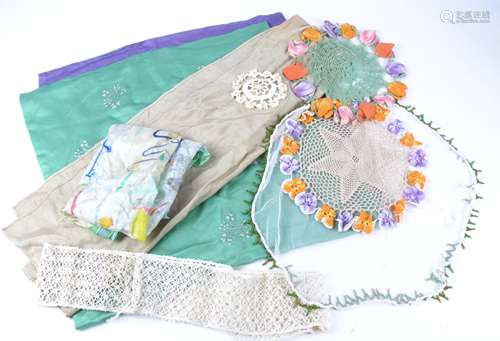 A large quantity of 20th Century textiles, including embroidered tablecloths and placemats on