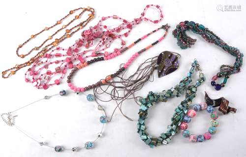 A quantity of costume jewellery to include mother of pearl strung with beads tinted in pinks and