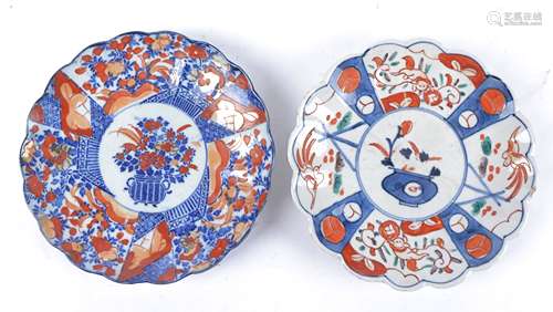 A pair of Oriental Imari design plates of floriform, both with central baskets of flowers and one