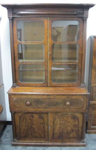 A 19th century figured mahogany secretary bookcase, the top section having a moulded cornice above a