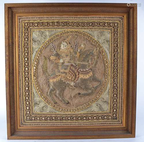 Two Indian or South East Asian framed textile panels with raised figural decoration, one riding an