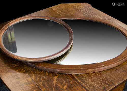 An Edwardian oval mirror, the bevel edged oval mirror with chequered strung decoration, 75cm x