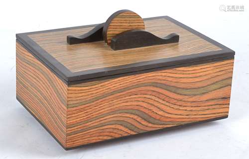 Paul Swan (Contemporary British) an aromatic man made veneer and bog oak box entitled 'wave motion',