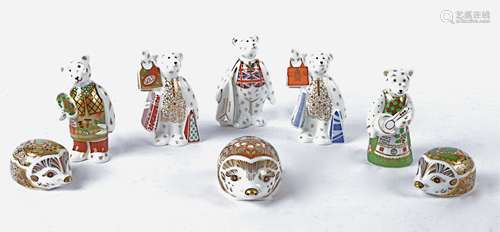 Eight Royal Crown Derby paperweights and figures, the three paperweights being hedgehogs with gold