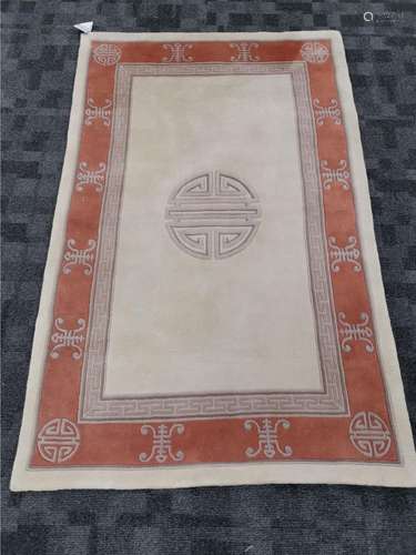 A Peking Oriental rug with central shou symbol, on a cream ground with a key fret border, 187cm x