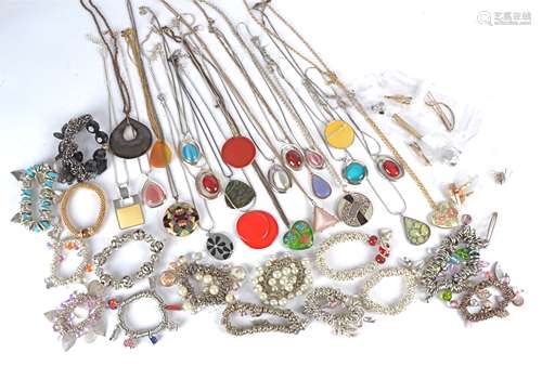 A collection of costume jewellery, pendants, charm bracelets, beaded bracelets, cufflinks, tie clips