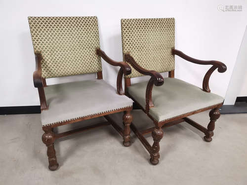 A pair of 'Boet' oak framed lounge chairs, with scroll arms, green upholstery (faded). Floor to