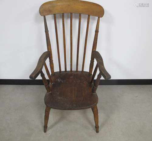 A 19th century beech and elm stick back arm chair, raised on turned supports