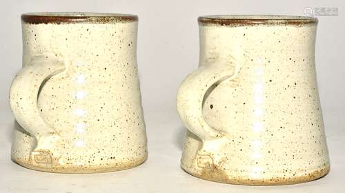 Michael Cole (Contemporary) a pair of stoneware ash and iron glazed thrown mugs, with strap