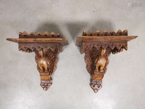 A pair of carved oak wall bracket shelves, with carved bird form. Each measuring 38cm x 30cm x 23cm.