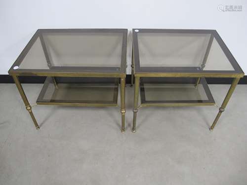 A pair of contemporary two tier occasional tables, glass tops and undershelves with brass metal