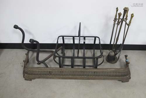 A collection of fire place furniture, metal log basket, antique pierced cast iron fender and brass