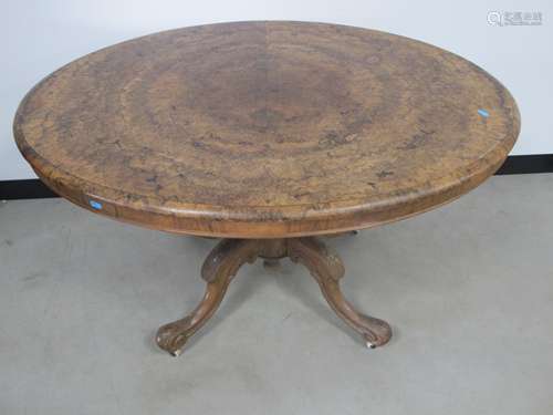 A Victorian burr walnut oval loo table, tilt top action supported on a bulbous reed column and a