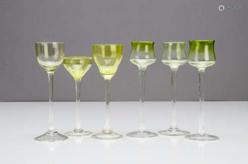 A set of three German Art Nouveau liquor glasses, the green tulip shaped bowls on a circular waisted