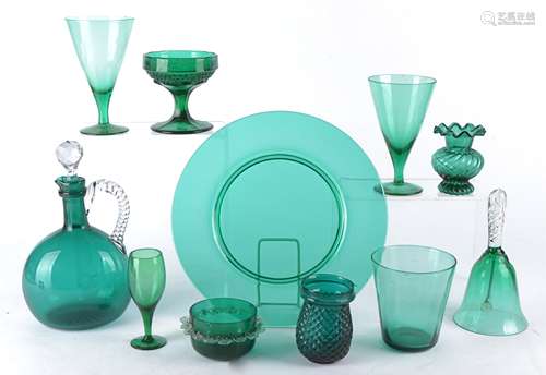 An emerald green glass decanter of bulbous form with clear twisted handled and multifaceted stopper,