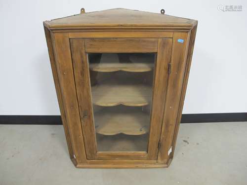 19th century waxed pine corner cupboard, glazed panelled door with three shaped fixed shelves to the