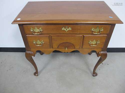 A late 19th century walnut low boy, moulded top, one long and three short drawers, shaped frieze,