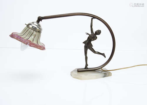 An Art Deco spelter, alabaster and iridescent glass table lamp, the figural table lamp in the