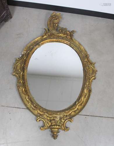 A 19th century oval wall mirror, with a gilded wooded gesso / plaster frame, 90cm x 140cm A/F