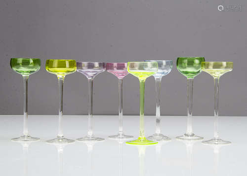 A set of eight shallow bowled Art Nouveau liquor glasses, each bowl in varying colours of green,