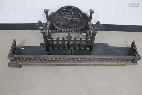 A cast iron fire grate, with a decorative back panel of a inn scene with seated figures, 40cm x 27cm