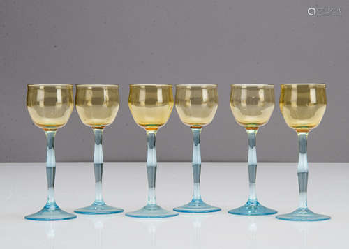 Six German Art Nouveau liquor glasses, the tulip shaped amber bowls supported on shaped blue stems