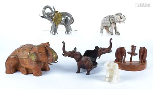 A selection of elephant models, wooden, metal and bone examples, including a cast iron plant stand