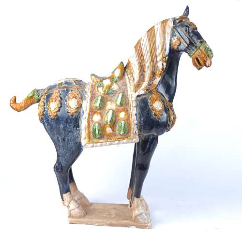 A large 20th Century Chinese sancai glazed statue of a horse after the Tang, a/f with loss to ear,