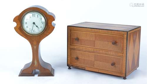 An Art Nouveau mantle clock of balloon form, circular enamel dial with Arabic numerals, the mahogany