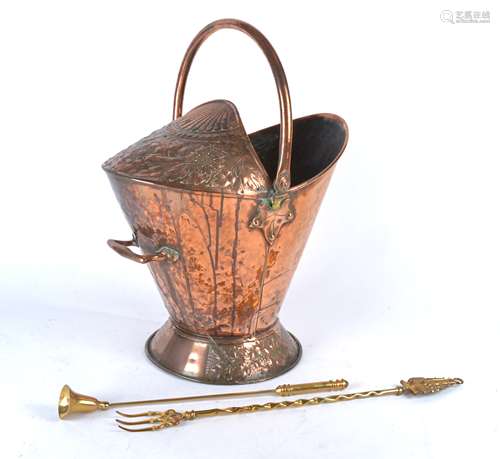 An Arts and Crafts copper coat bucket, with swing handle, above repousse decorated Art Nouveau