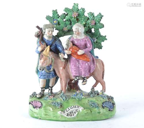 A Georgian Walton pearlware Staffordshire figure 'Flight to Egypt', with Joseph, Mary and baby Jesus