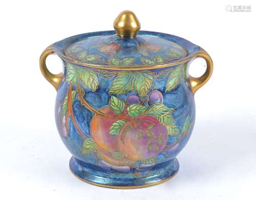 A Maling lustre biscuit barrel, decorated in the 'Plum and Orchard' pattern, heightened in