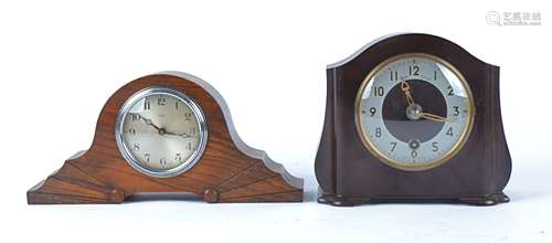 Two mid 20th Century Enfield mantle clocks, one in a oak case with carved decoration, height 15.5cm,