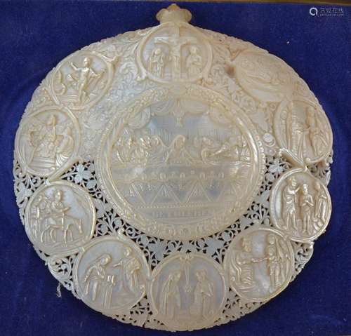 A 19th Century mother of pearl pilgrim dish, with oval cartouche of the last supper, surrounded by