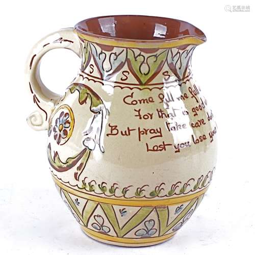 An Aller Vale pottery jug with cream glaze and sgraffito decoration, with the motto 