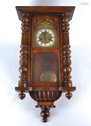 A early 20th Century mahogany cased wall clock, white enamel dial with Roman numerals, mounted on