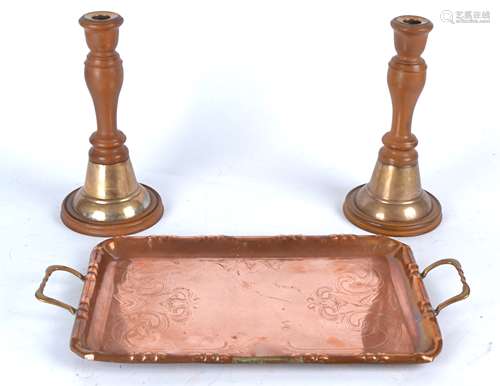 A pair of early 20th Century vulcanite and brass candlesticks, height 25cm, together with a copper